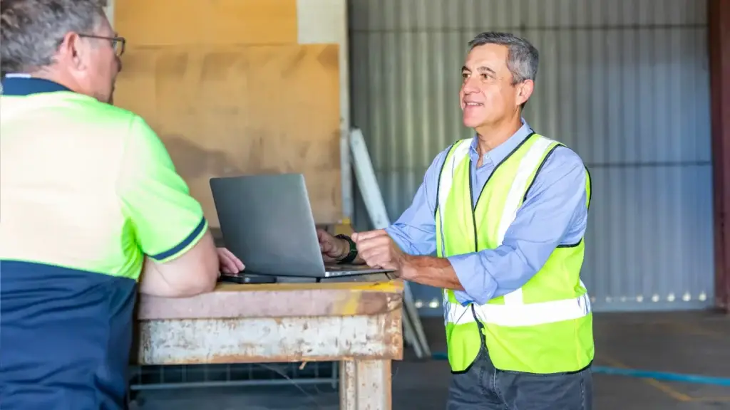 Business Owner Working Through Cash Flow Projections in Warehouse